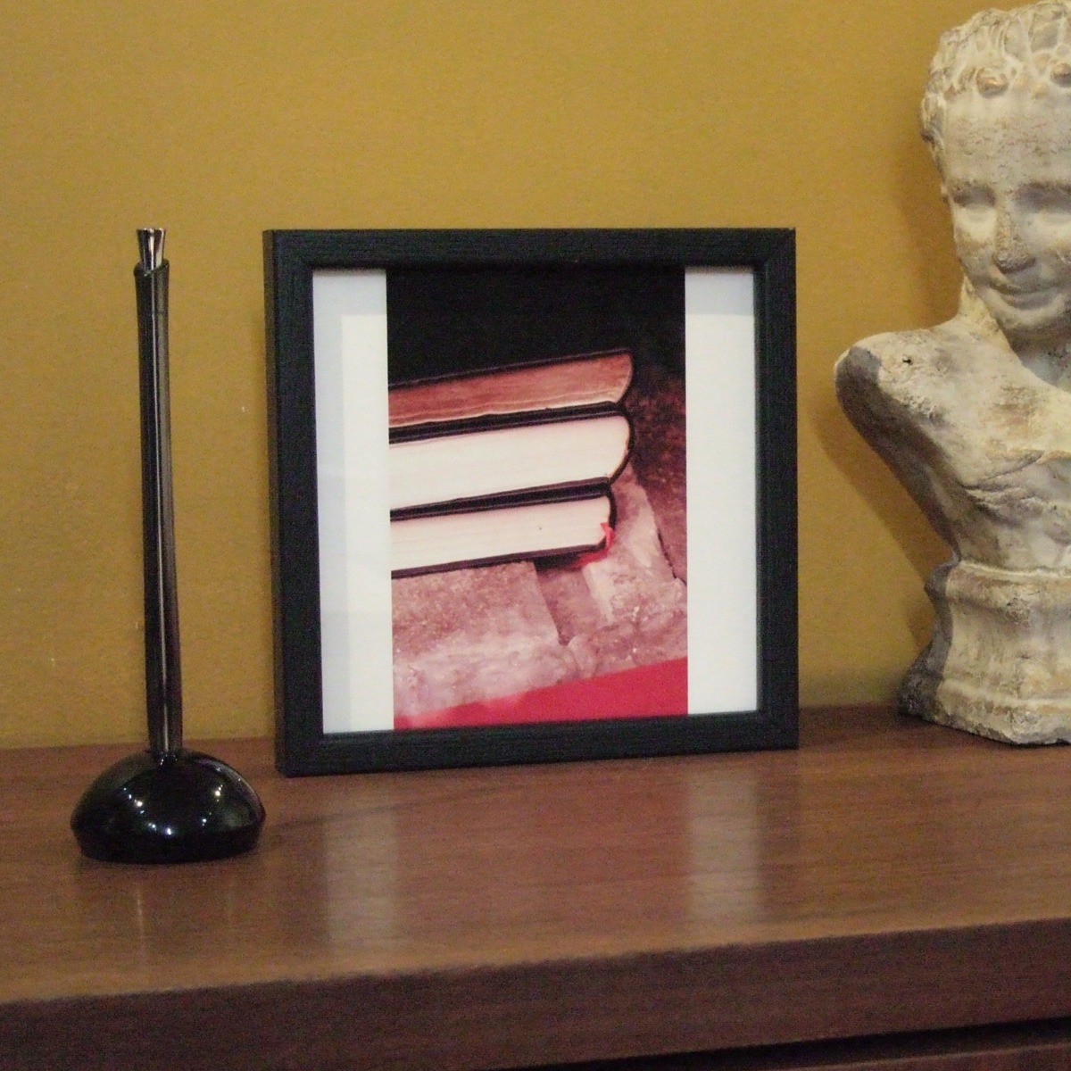 黒のウッドフレームで額装してキャビネットの上に飾る